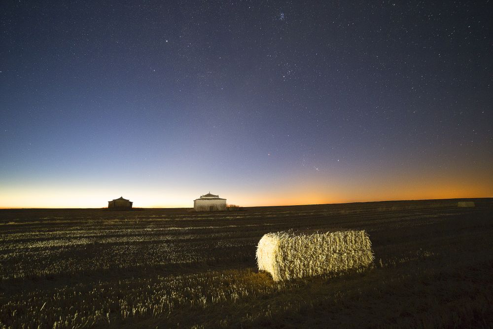 Rural fields in night with glowing sky