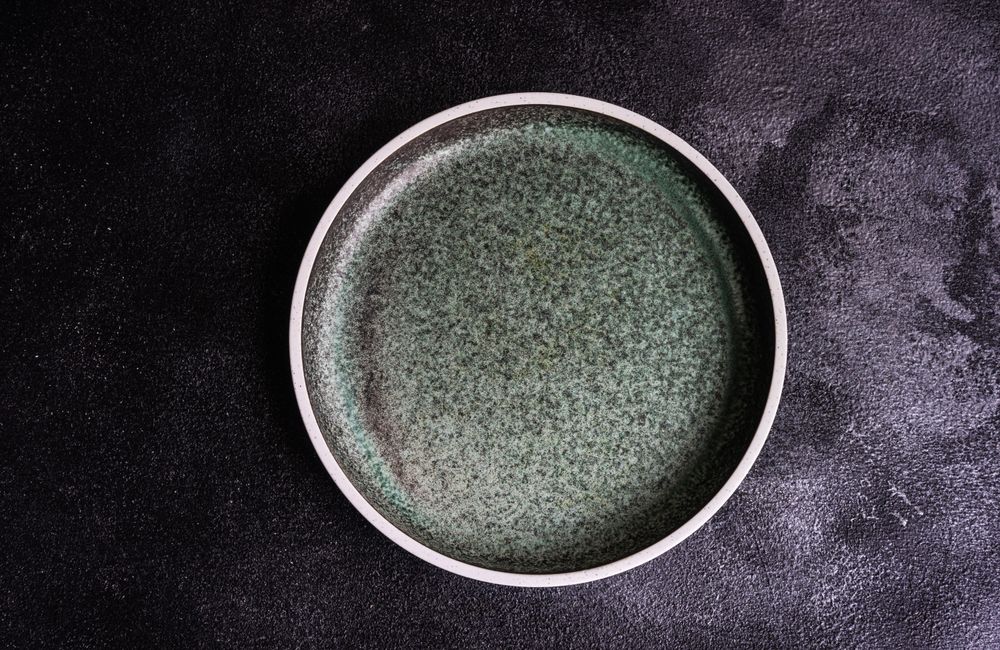 Empty grey ceramic plate table setting concept