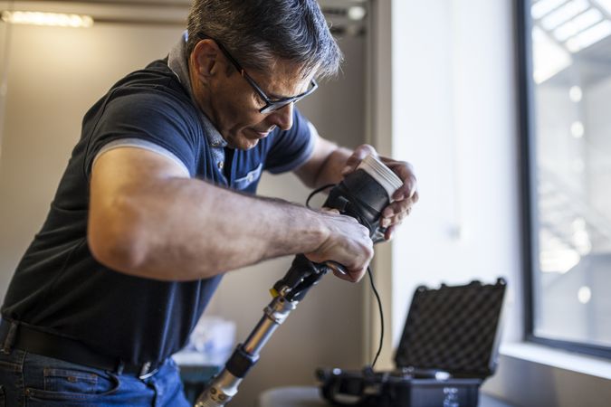 man fixing a prosthesis in a workshop
