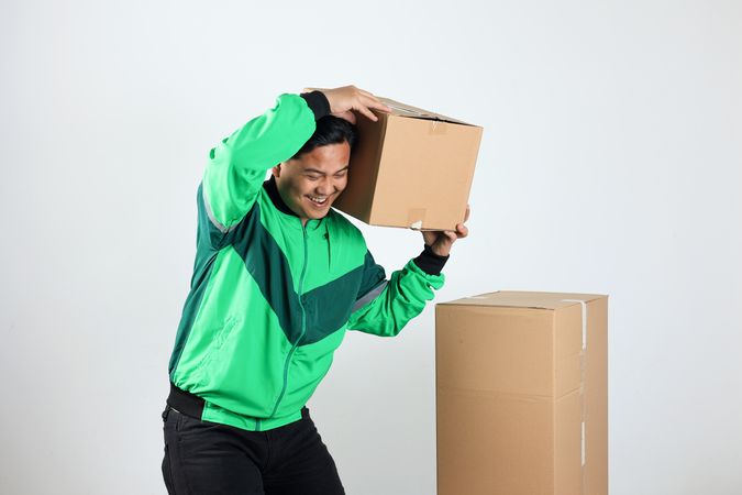Online Motorcycle Driver Smiling While Driver Holding Carboard