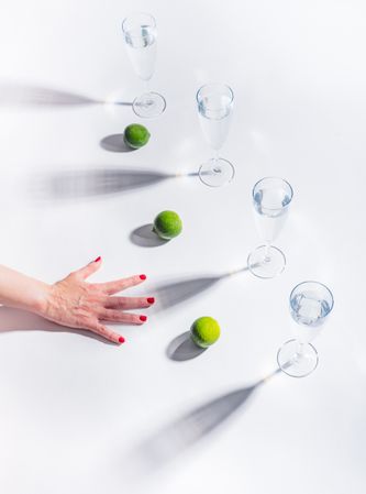 Composition of a hand with citrus and glasses of water