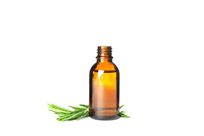 Rosemary oil in jar isolated on neutral background