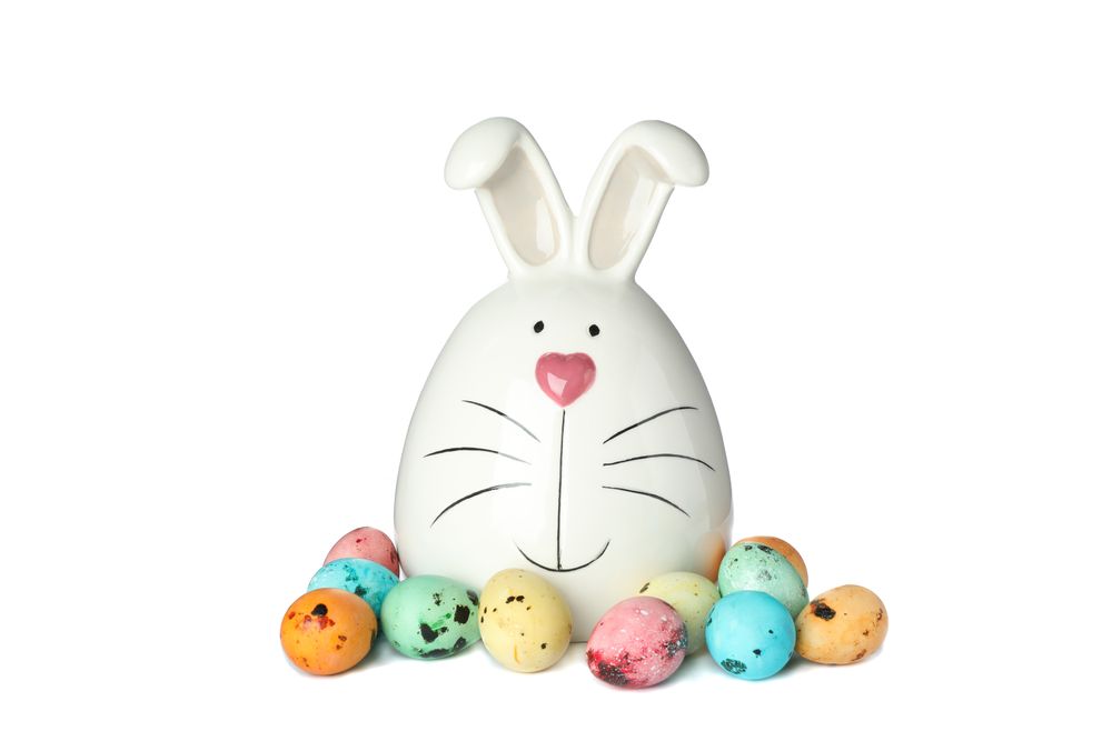 Decorated bunny and Easter eggs isolated on plain background. Festive tradition