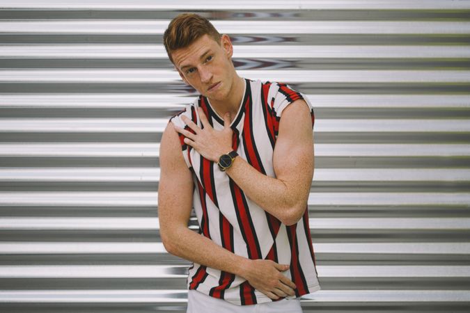 Man leaning on steel garage door