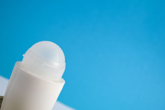 Top of round deodorant bottle on blue background