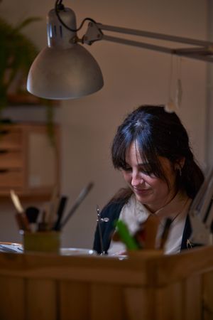Concentrated woman working in jewelry workshop