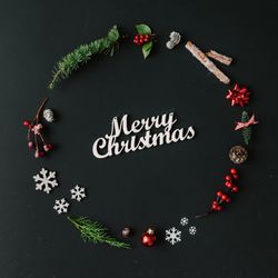 Christmas wreath made of winter items on dark background