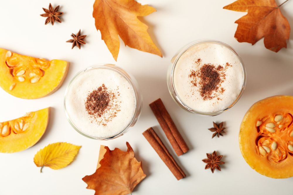 Composition with pumpkin latte on neutral background, top view