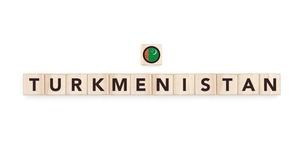 Wooden blocks bearing the name and flag of Turkmenistan. Turkmenistani and Asian Culture, national identity, travel, and geography in a copy space design.