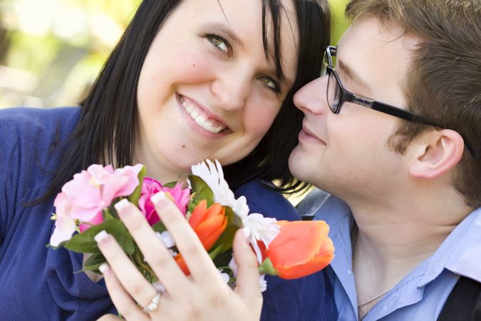 Young Man Gives Flowers to His Love