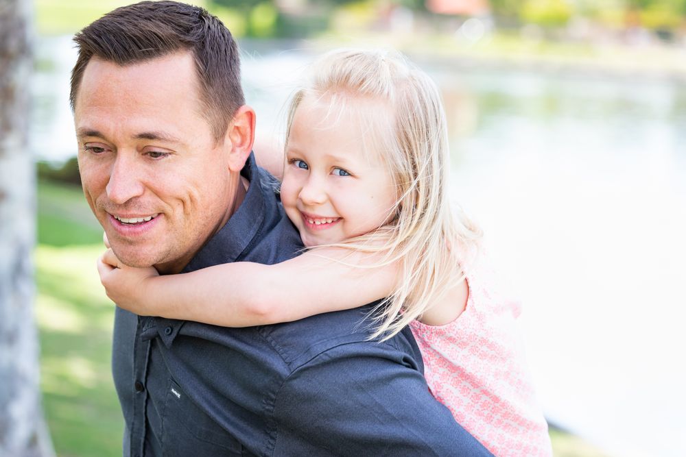 Young Father and Daughter Having Fun At The Park