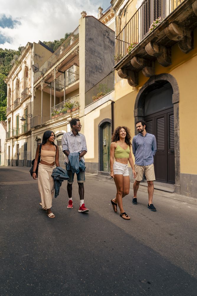 Group of friends walking in a historic Italian town