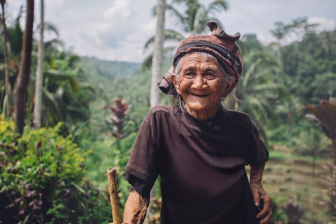 Portrait of happy older woman with a cane in village
