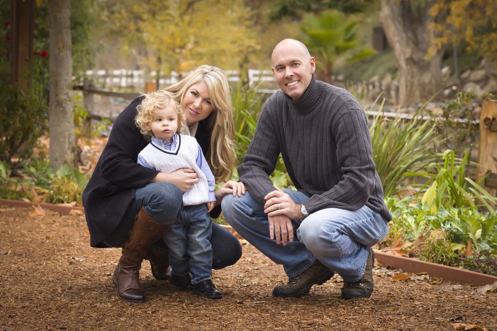 Parents and Child Posing in Park