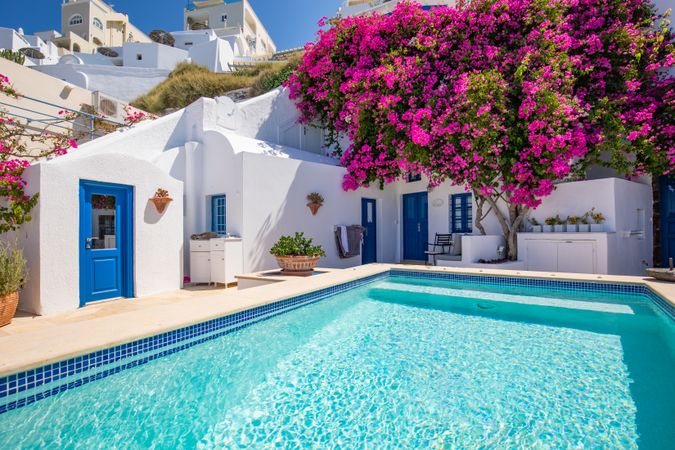 Idyllic pool with beautiful pink tree in Greece