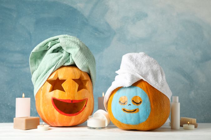 Funny pumpkins and skin care accessories, copy space