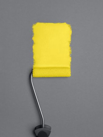 Yellow paint stroke with a roller brush on gray background