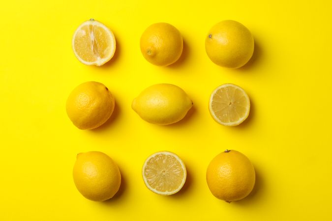 Flat lay composition with lemons on yellow background