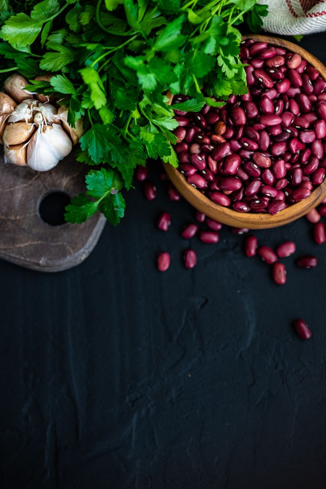 Top view of close up bowl of dried kidney beans on kitchen counter 