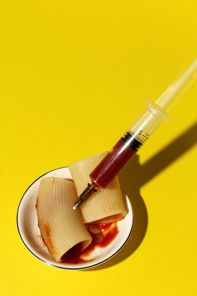 Stuffed pasta with red sauce in syringe