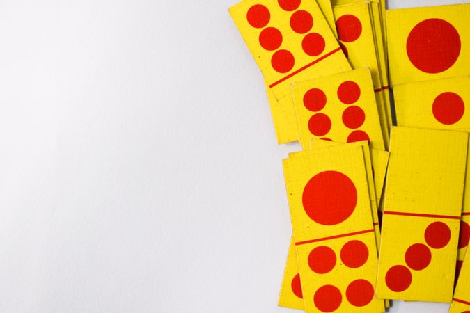 Looking down at red and yellow domino cards with space for text
