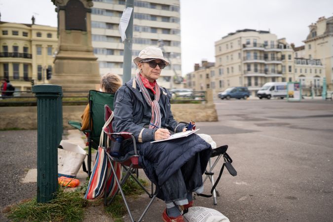 Man sitting outside drawing