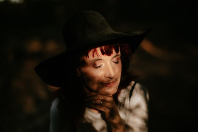 Woman with closed eyes in forest