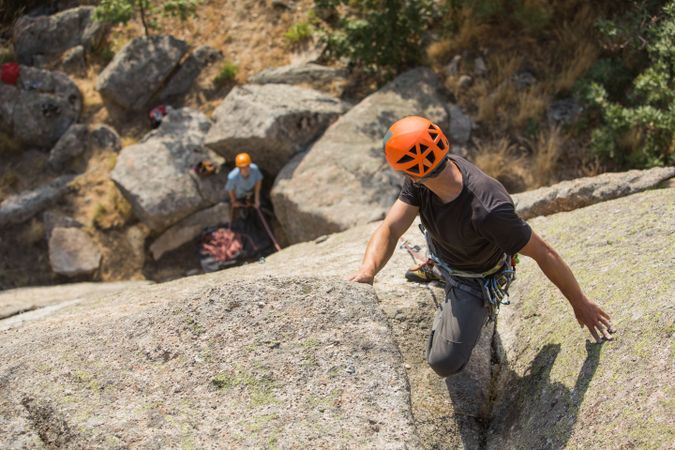 Climbers in safety harness climbing mountain