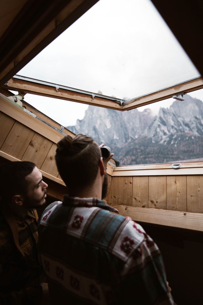 Men in casual wear enjoying views from ceiling window