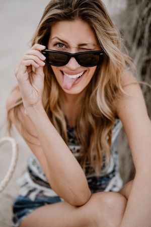 Portrait of young cheerful woman with sunglasses