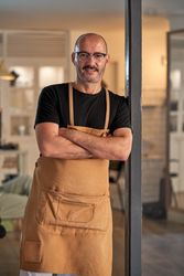 Confident man with mustache in glasses in light room