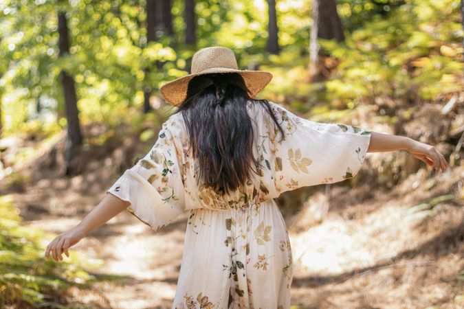 Rear view of a woman walking in the forest