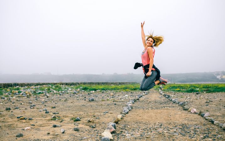 Young sportswoman jumping on the road