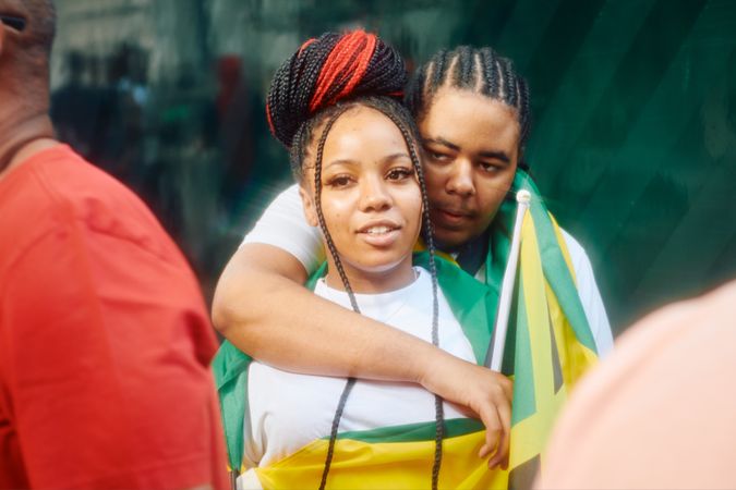 London, England, United Kingdom - August 27, 2022: Couple draped in Jamaican flag