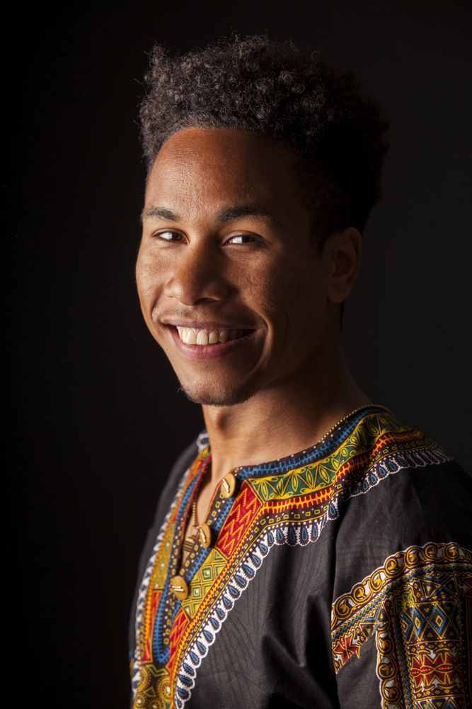 Black man smiling and looking at camera