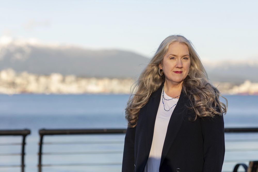 Professional woman standing outside in front of a bay
