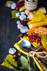 Wooden table with seasonal nuts, berries, vegetable and fruits for fall