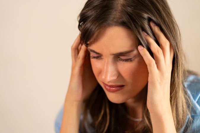 Woman Experiencing Stress and Headache - Emotional Pain and Discomfort