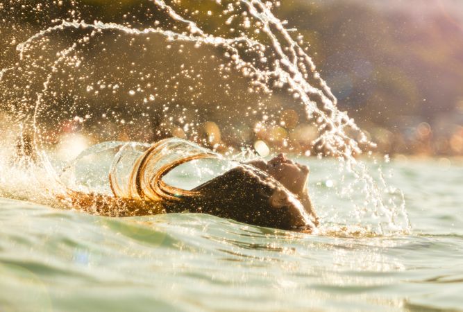 Woman shaking hair in water