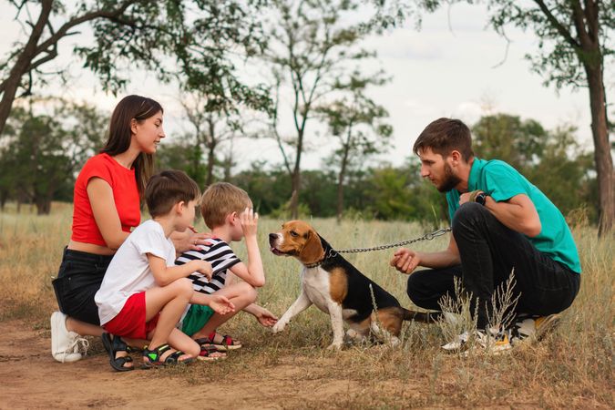 Family walk and training dog