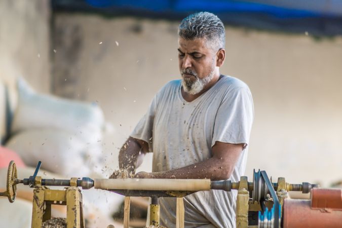 Man using woodworking machine at workplace