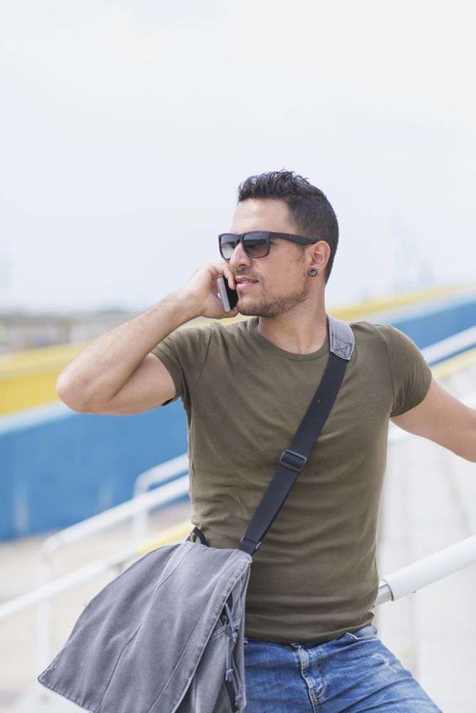 Male turning around on outdoor stairs talking on cellphone