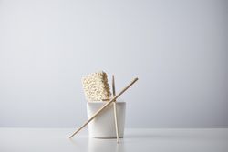Dry noodles, chopsticks and take away container
