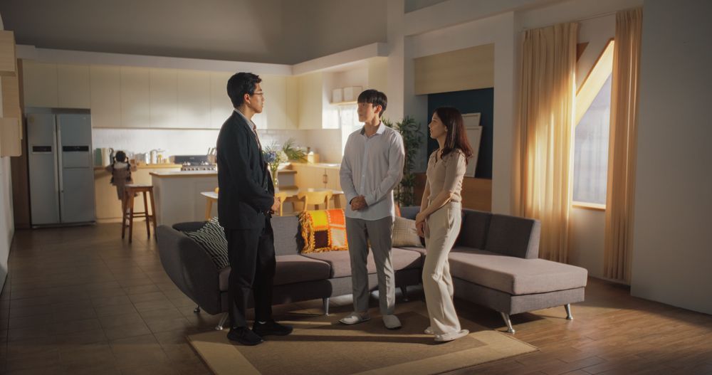 Professional Real Estate Agent Welcomes Young Couple at Home Showing.