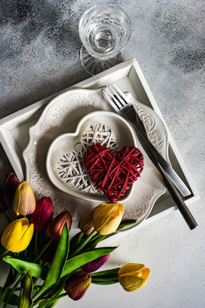 St. Valentine's Day card with plates, crystal, heart ornaments and tulips