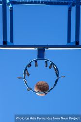 Street basketball ball falling into the hoop 0gJPAb