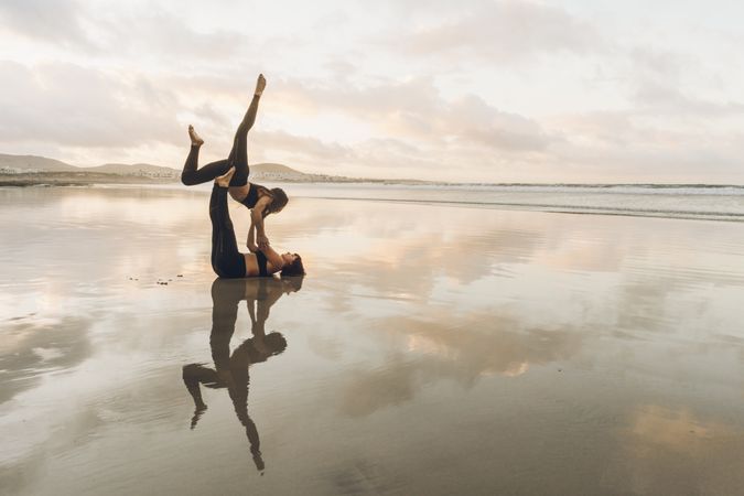 Women exercising near sea