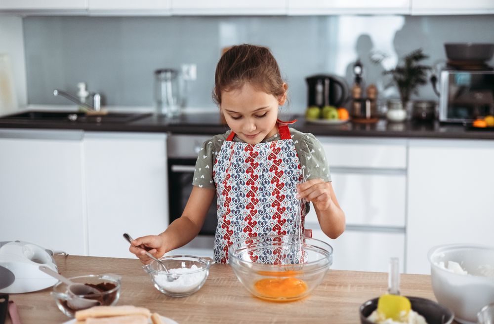 tiramisu making process in bright kitchen