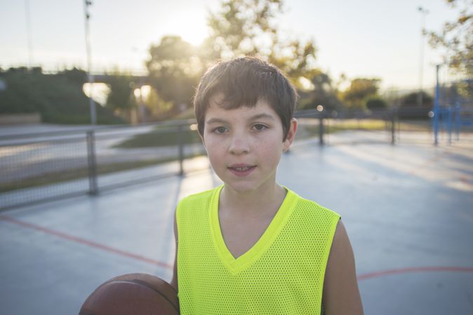 Portrait of a young teen wearing a yellow basketball sleeveless