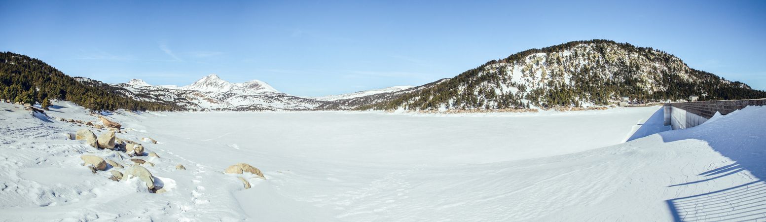 Picturesque view of mountains with forest in snow